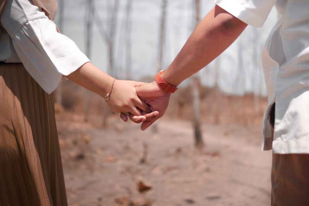 Cheating spouse holding hands